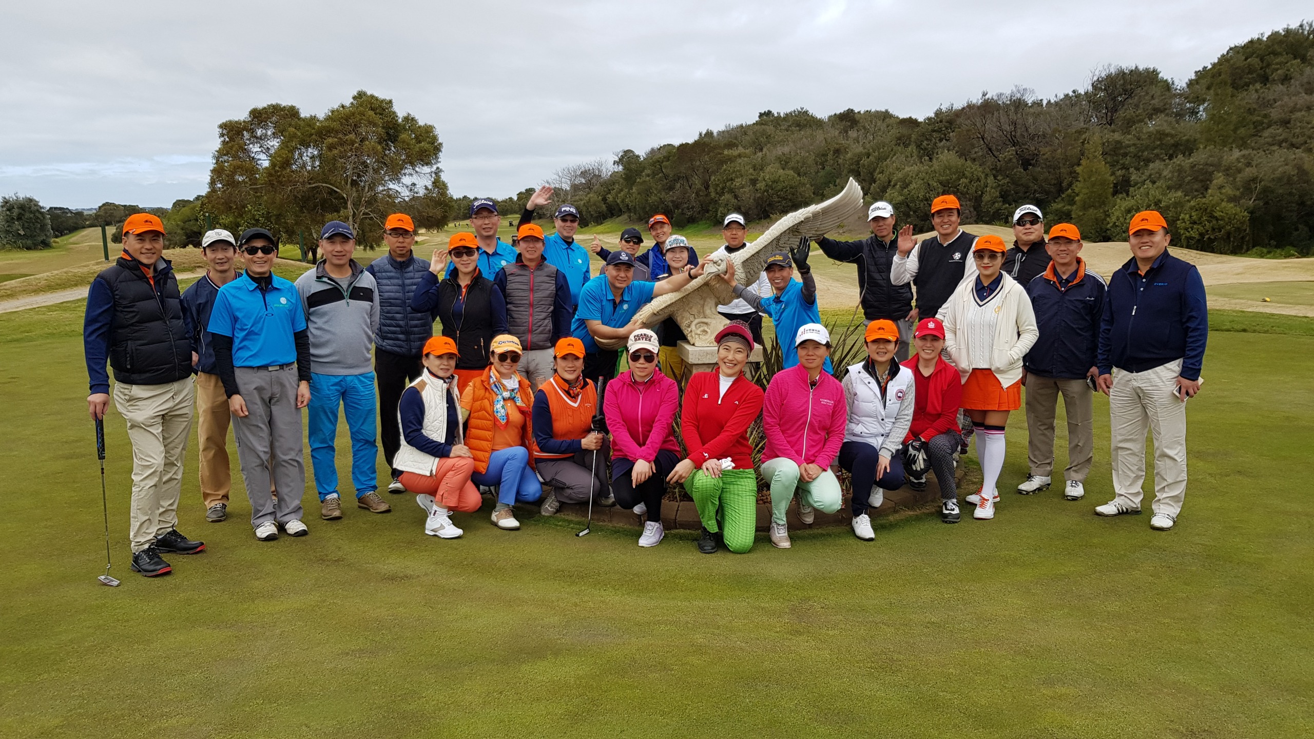 Group of golfers standing in front of the large eagle at Eagle Ridge Golf Course on the Mornington Peninsula